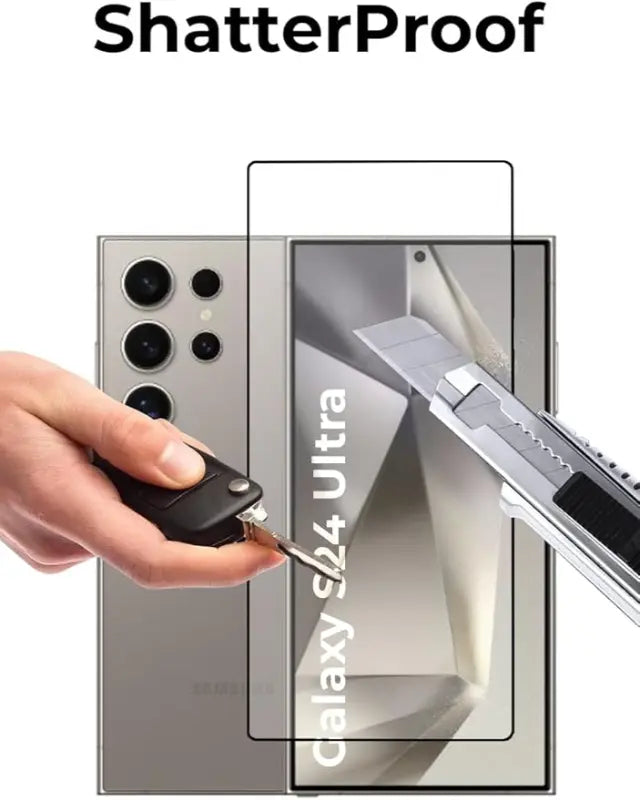 Samsung Galaxy S24 Ultra phone with a shatterproof screen protector being cut by a knife.