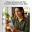 Woman using a smartphone with a magnetic power bank on a table, promotional text about a powerful magnetic power bank.