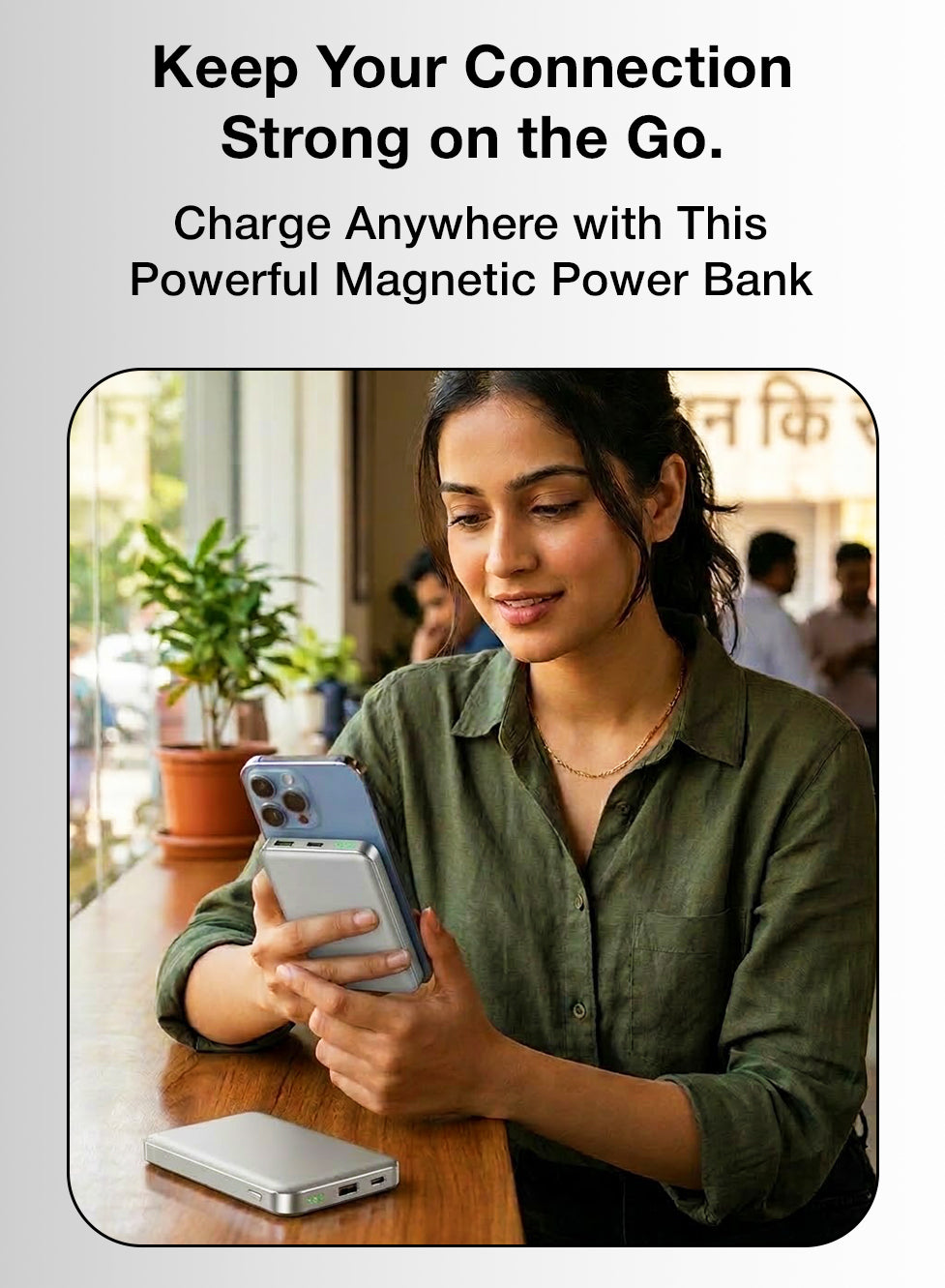 Woman using a smartphone with a magnetic power bank on a table, promotional text about a powerful magnetic power bank.
